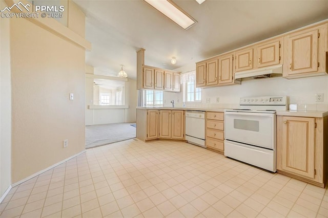 kitchen with light carpet, light brown cabinets, and white appliances