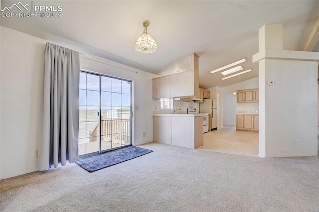 unfurnished living room featuring light colored carpet and vaulted ceiling