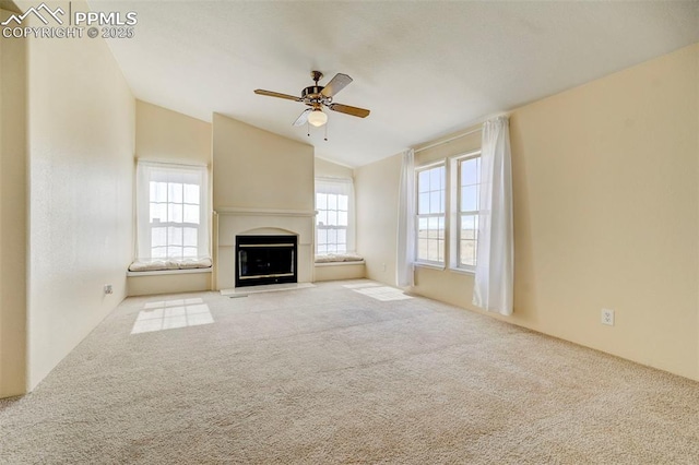 unfurnished living room featuring light carpet, vaulted ceiling, and ceiling fan