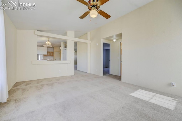 unfurnished living room with ceiling fan, light carpet, and vaulted ceiling