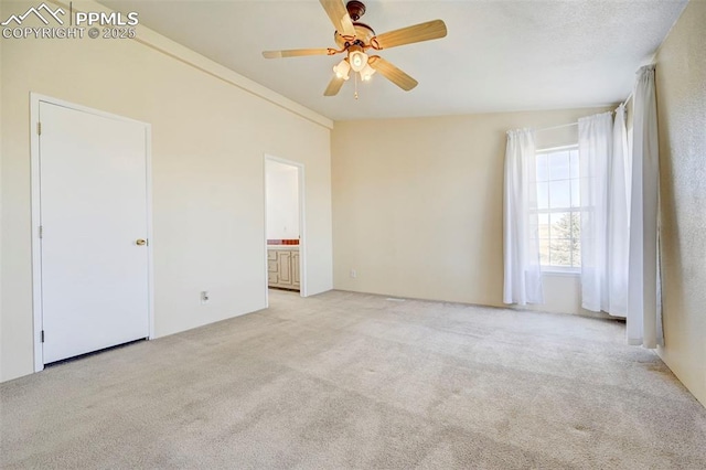 carpeted spare room with ceiling fan