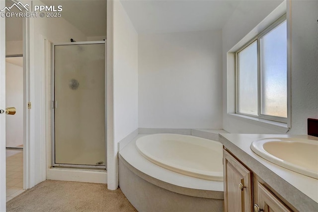 bathroom featuring vanity and independent shower and bath