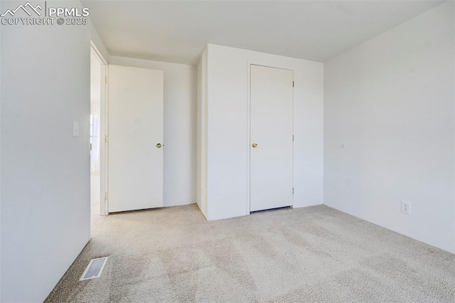 unfurnished bedroom with light colored carpet