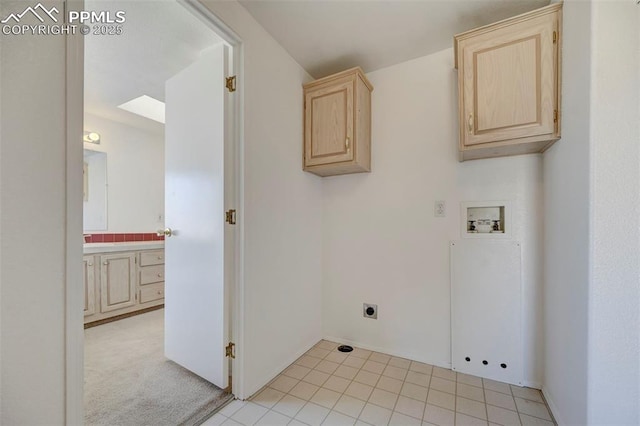 clothes washing area featuring cabinets, washer hookup, and light colored carpet