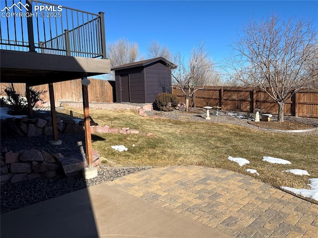 view of yard featuring a patio and a storage shed