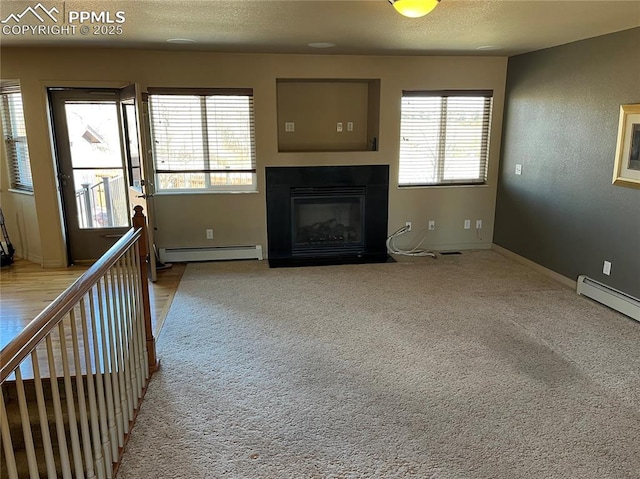 unfurnished living room with baseboard heating and light colored carpet