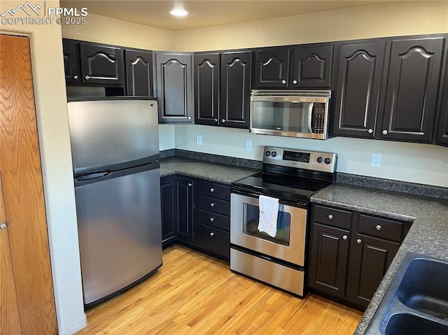 kitchen featuring appliances with stainless steel finishes, light hardwood / wood-style floors, and sink