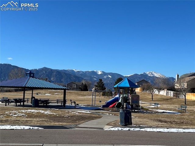 surrounding community with a gazebo, a playground, and a mountain view