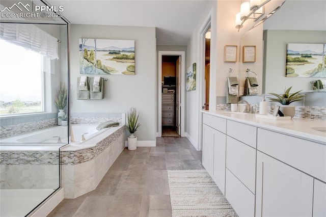 bathroom with tiled bath and vanity