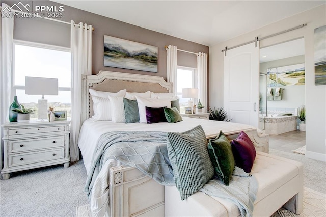 bedroom featuring light colored carpet and a barn door