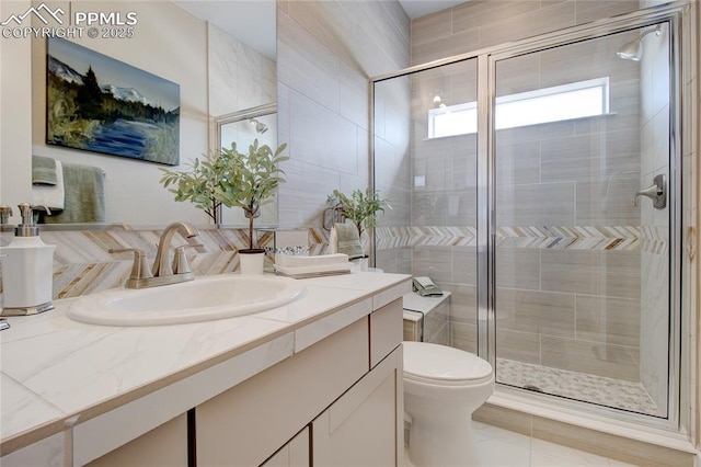 bathroom featuring vanity, toilet, walk in shower, and tile patterned flooring