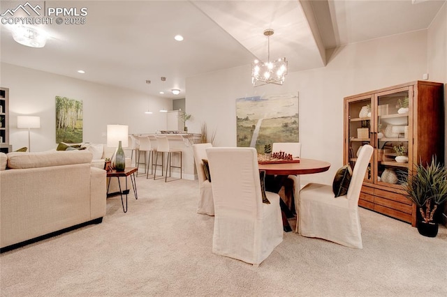 carpeted dining space featuring an inviting chandelier