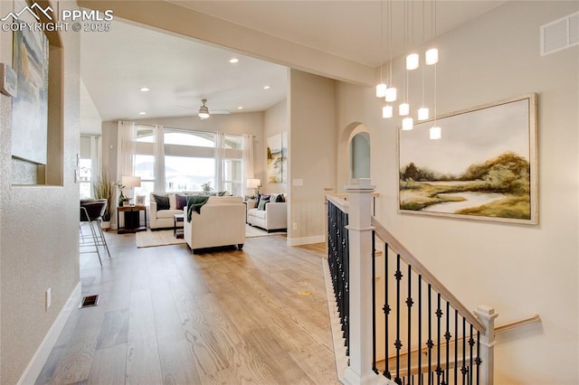 hall featuring light hardwood / wood-style flooring and vaulted ceiling