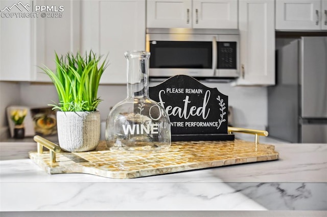 interior details with white cabinets and light stone counters