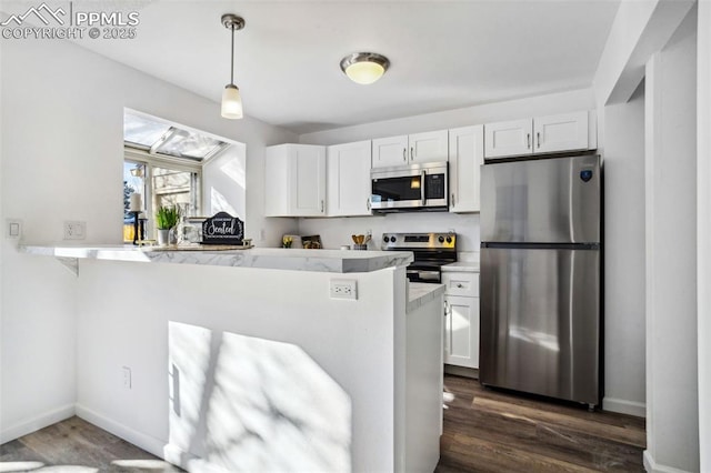 kitchen featuring kitchen peninsula, dark hardwood / wood-style floors, stainless steel appliances, and white cabinetry