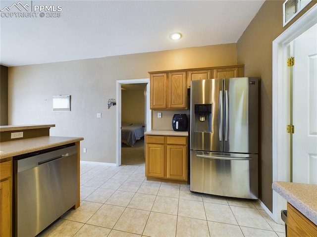 kitchen with stainless steel appliances and light tile patterned floors