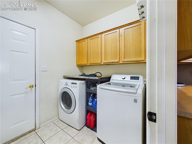 washroom with cabinets, light tile patterned flooring, and independent washer and dryer