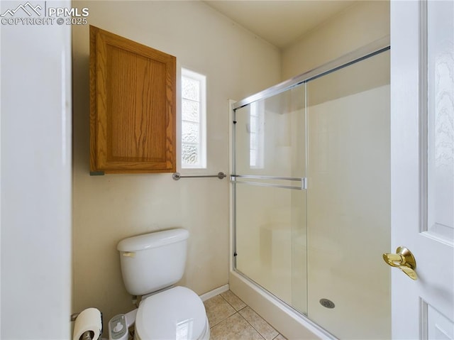 bathroom featuring toilet, an enclosed shower, and tile patterned flooring