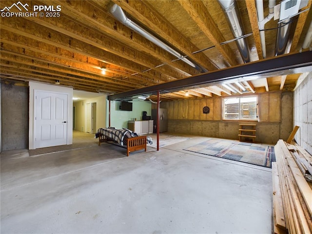 basement featuring separate washer and dryer and water heater