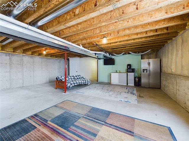 basement featuring stainless steel fridge