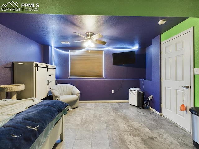 interior space with a textured ceiling and ceiling fan