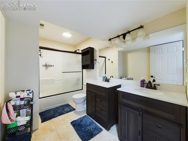 full bathroom featuring enclosed tub / shower combo, vanity, toilet, and tile patterned floors