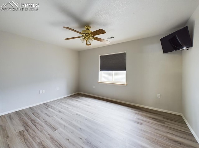 unfurnished room featuring ceiling fan and light wood-type flooring