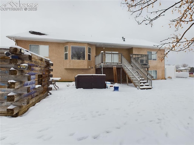 view of snow covered rear of property