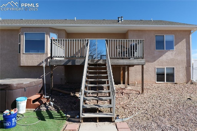 rear view of house featuring a hot tub