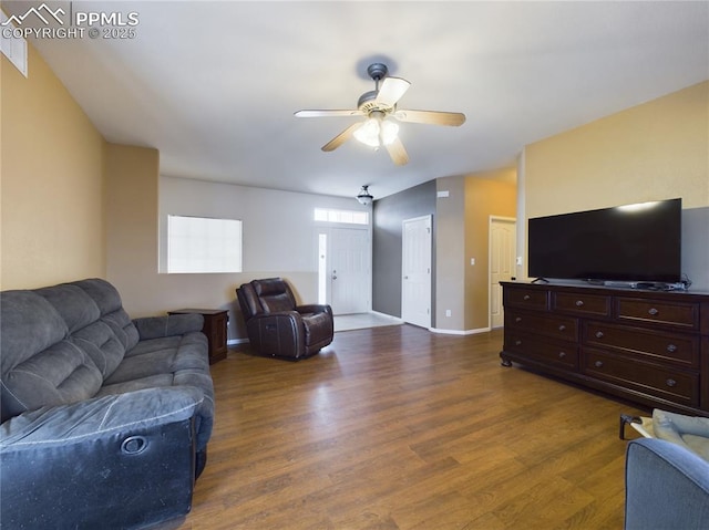 living room featuring dark wood-type flooring and ceiling fan