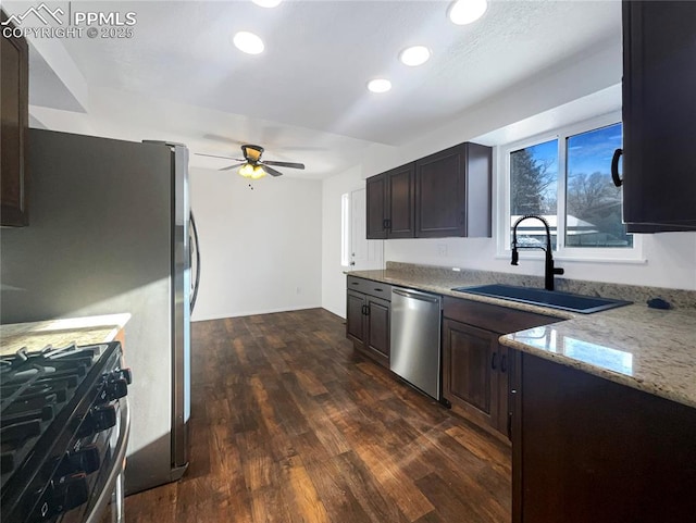 kitchen with dark hardwood / wood-style flooring, sink, dark brown cabinets, and stainless steel appliances