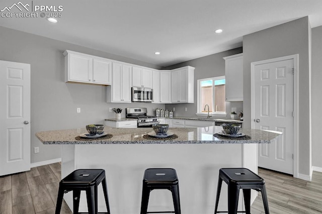 kitchen with a center island, white cabinets, and appliances with stainless steel finishes