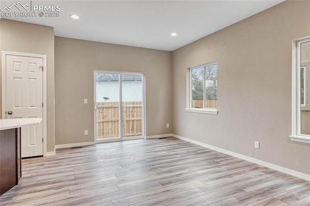 spare room featuring light hardwood / wood-style flooring