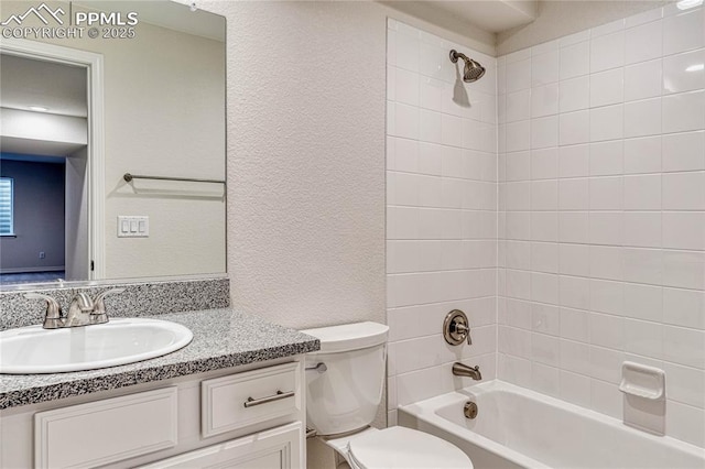 full bathroom with tiled shower / bath combo, toilet, and vanity