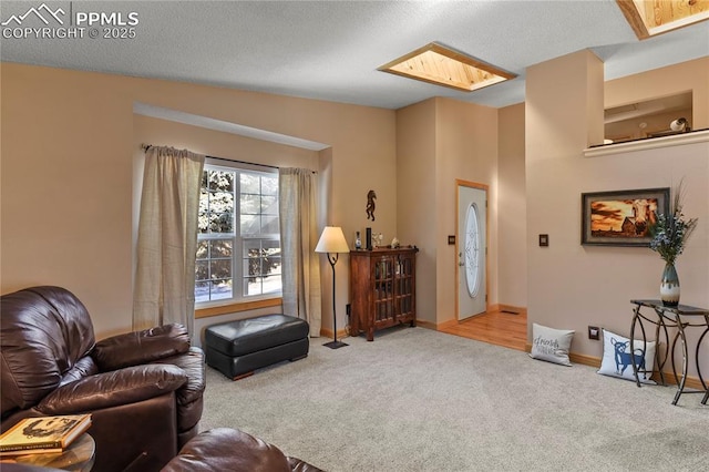 living room featuring carpet and lofted ceiling with skylight