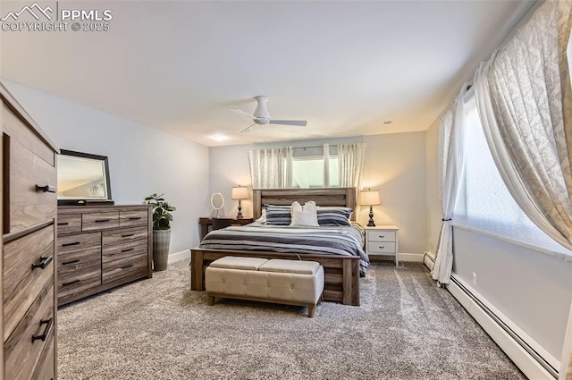 carpeted bedroom with a baseboard heating unit, ceiling fan, and multiple windows