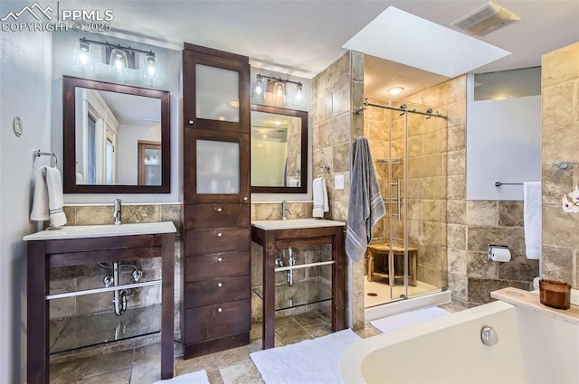 bathroom featuring vanity, tile walls, and plus walk in shower