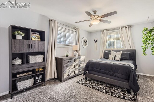 carpeted bedroom with ceiling fan and multiple windows