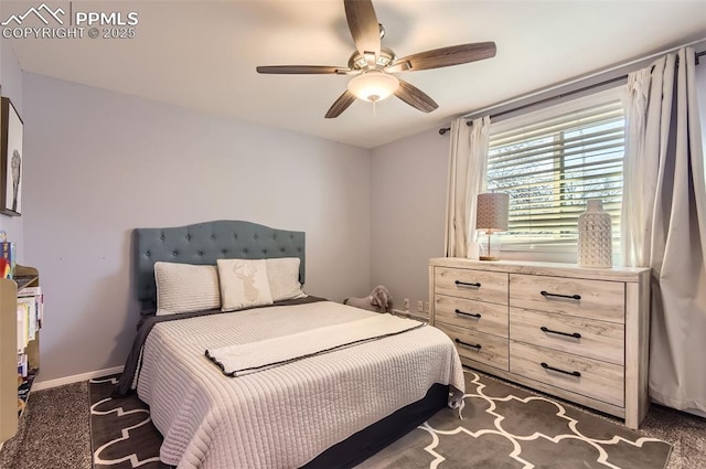 bedroom with ceiling fan and dark colored carpet