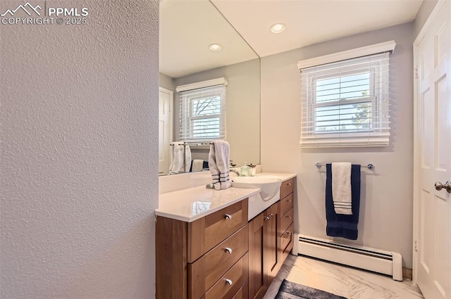 bathroom with vanity and a baseboard radiator