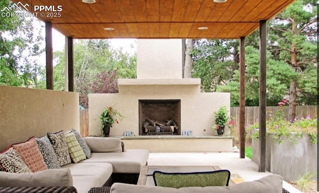 view of patio / terrace with an outdoor living space with a fireplace