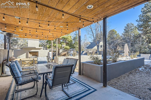 view of patio with an outdoor fireplace