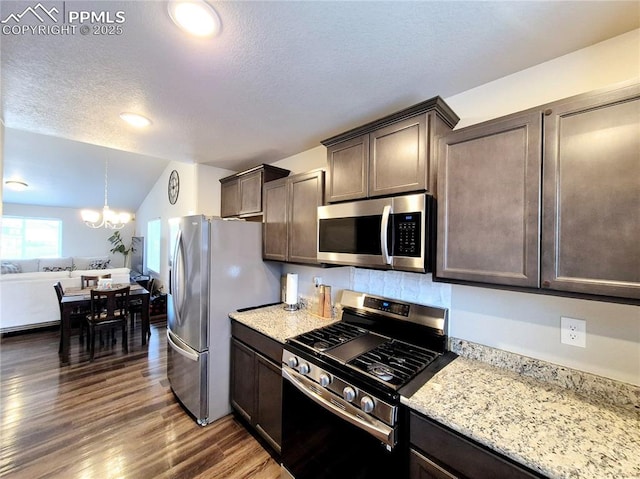 kitchen featuring dark brown cabinetry, dark hardwood / wood-style flooring, an inviting chandelier, and appliances with stainless steel finishes