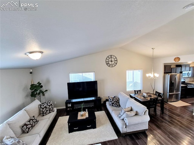 living room with dark hardwood / wood-style flooring, a chandelier, vaulted ceiling, and a textured ceiling