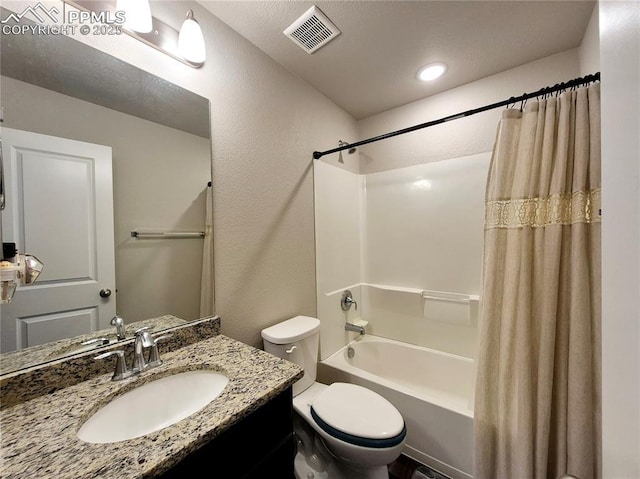 full bathroom featuring vanity, shower / bath combo with shower curtain, and toilet