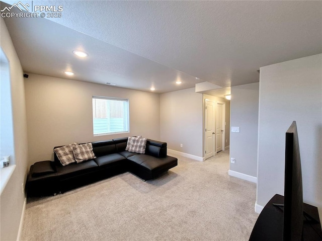 living room with light carpet and a textured ceiling