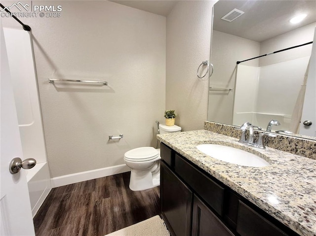 bathroom with hardwood / wood-style flooring, vanity, and toilet