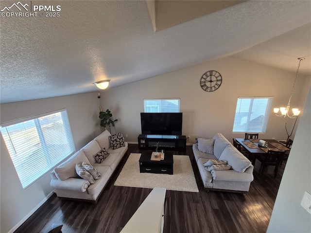 living room with lofted ceiling, a wealth of natural light, dark hardwood / wood-style floors, and a chandelier