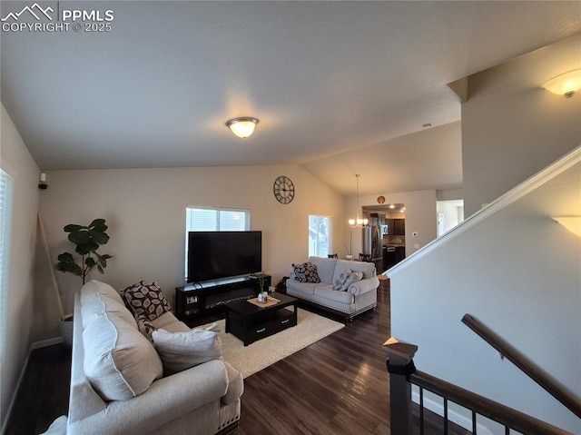 living room with lofted ceiling, a chandelier, and dark hardwood / wood-style flooring