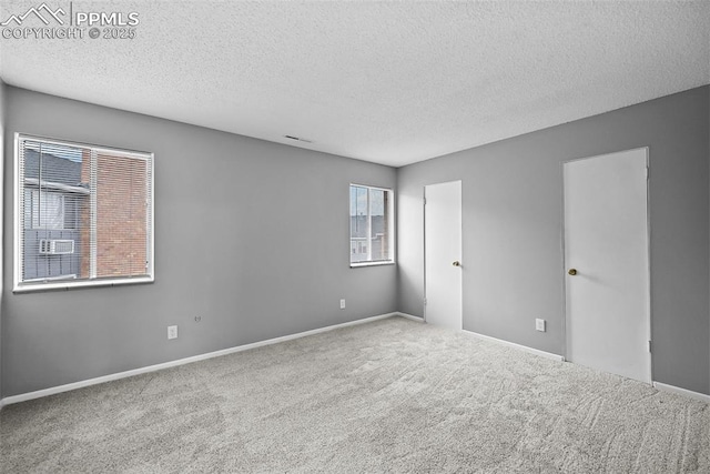 carpeted spare room featuring a textured ceiling